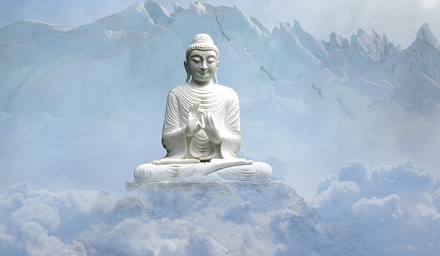 Photo of a Buddha statue in front of a mountaintop