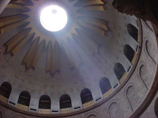 Sunlight beam coming through a circle in a church roof.