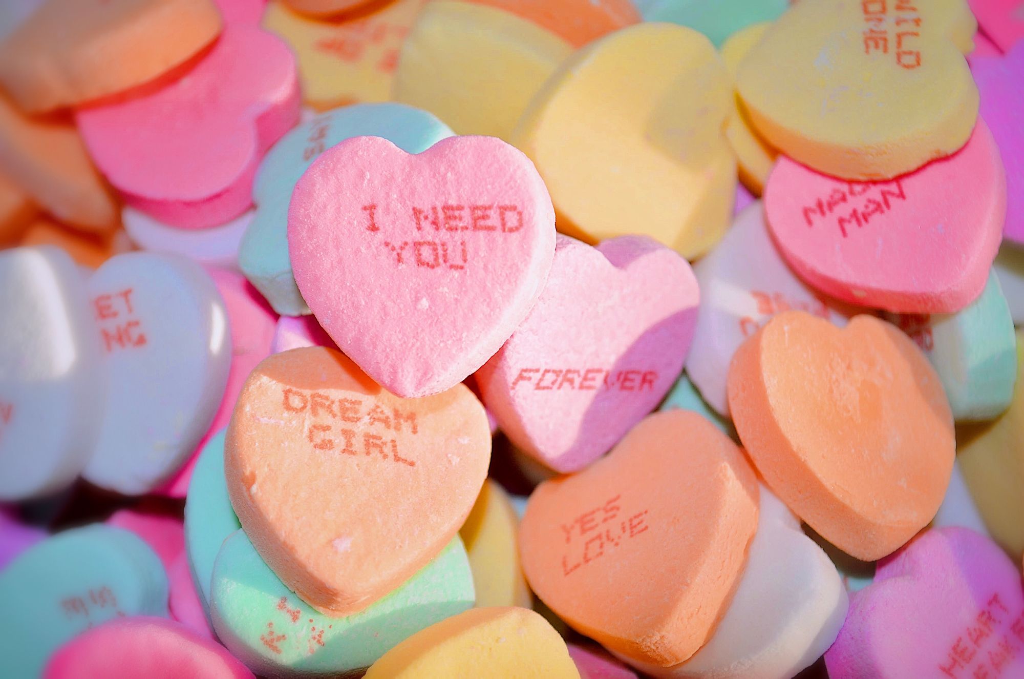 Candy hearts with words of love on them