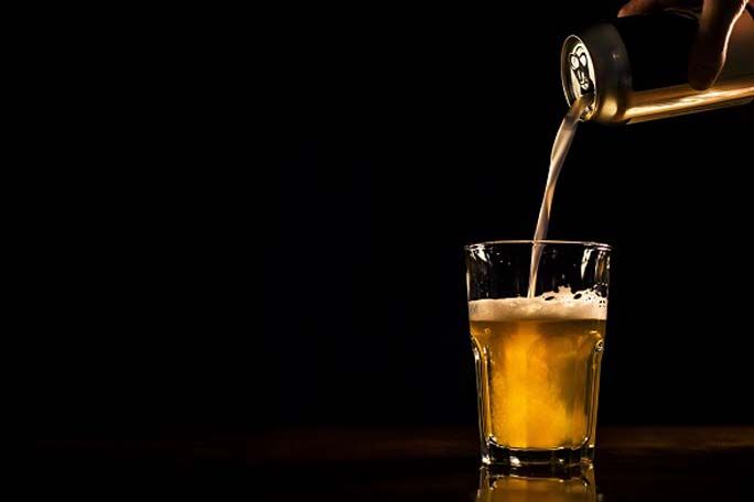 beer pouring from can to glass